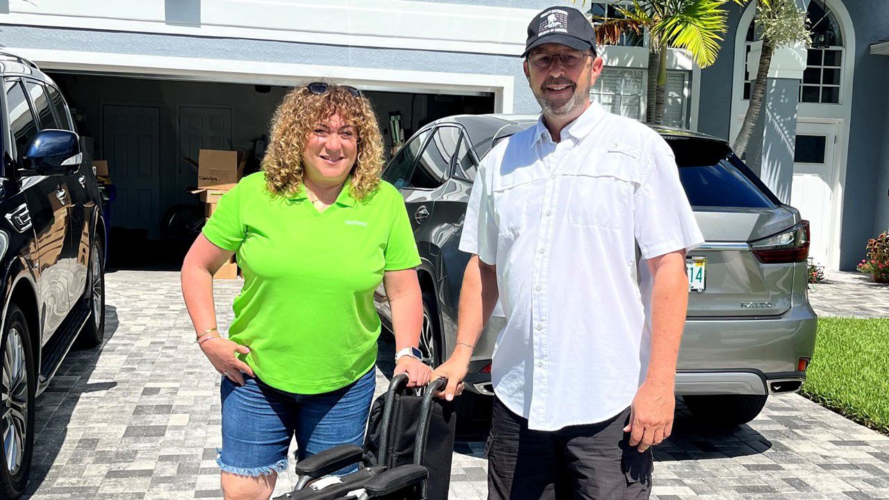 Man and woman delivering wheelchair to Humana member